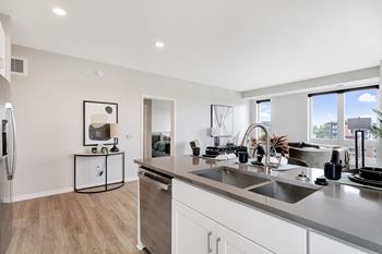 An open kitchen and living room with a large window